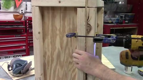 movers clamping a custom wooden shipping crate